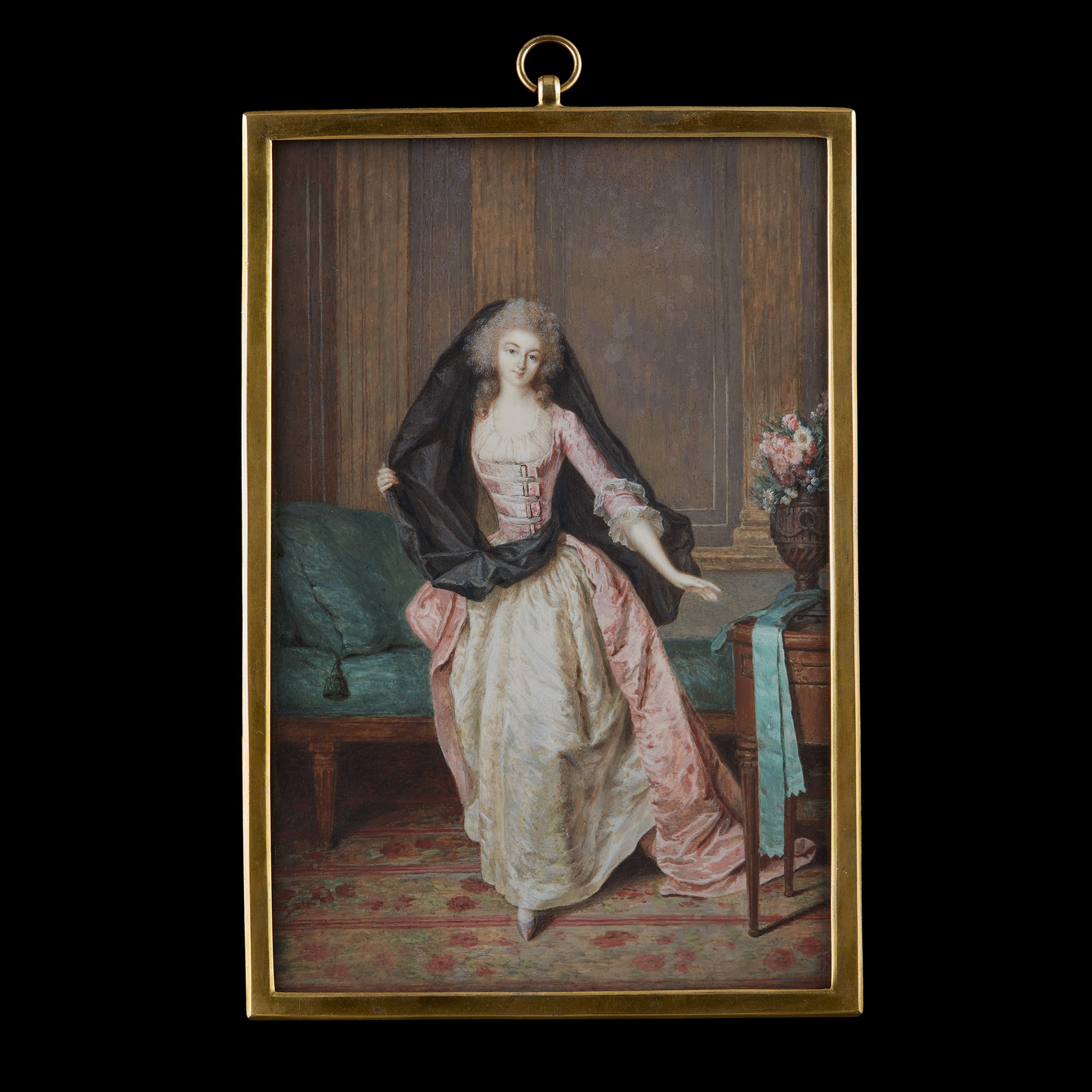 Portrait miniature of a Lady, traditionally called Louise Auguste Elisabeth Marie Colette, Princesse de Vaudémont-Lorraine (1763-1832/33), wearing pink satin dress with buckled bodice over white underdress and gauze fill-in, a black veil wrapped around her waist and over her head, she stands in an interior with pilasters, green upholstered chaise-longue and table bearing urn of flowers, a turquoise ribbon about its base